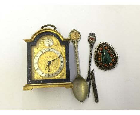 A small Swiza travelling clock together with a small silver green stone set brooch and other items.