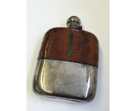 A crocodile leather half covered gentleman's hip flask with silver plated mounts.