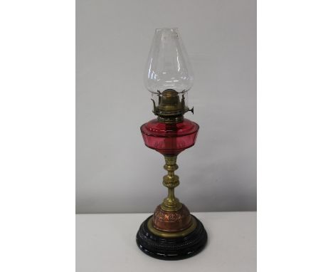 A nice quality brass & copper oil lamp with a cranberry glass reservoir.h50cm 