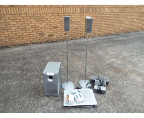 A stereo surround system by Yamaha to include twin wall speakers, sound bar, sub woofer, two floor speakers and a Tevion DVD 