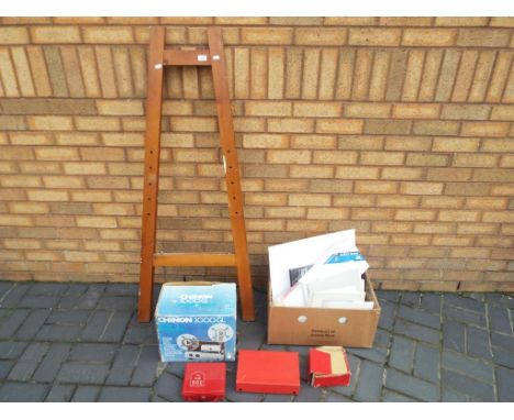 An artists easel with a quantity of canvases, a Chinon 2000GL Cine projector in a box, a Paterson Viscount slide viewer and 2