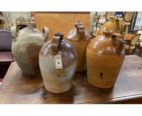Five earthenware and saltglazed flagons, three with light fittings attached, largest height 41cm