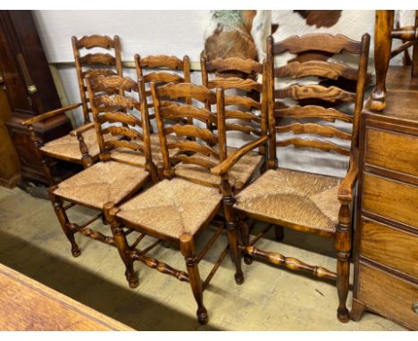 A set of eight reproduction elm and beech rush seat ladder back dining chairs, two with arms
