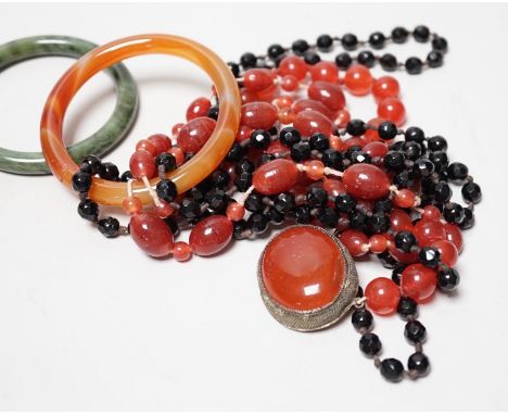 A spinach green Jade bangle and hardstone bead necklaces