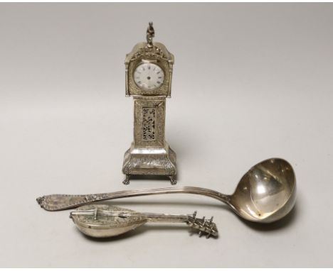 A Dutch white metal miniature longcase clock, 23.8cm, a similar model of a mandolin and a Victorian silver soup ladle by Geor