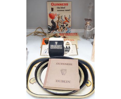 Five Guinness advertising signs, mirror,  trays and a book - St. James’s Gate Brewery History and Guide