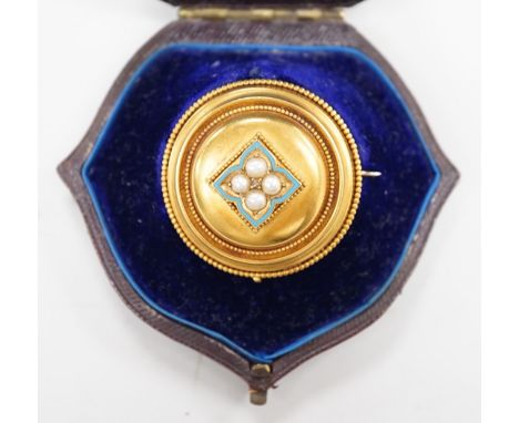A cased Victorian yellow metal, enamel and split pearl set circular mourning pendant brooch, the glazed back with lock of hai