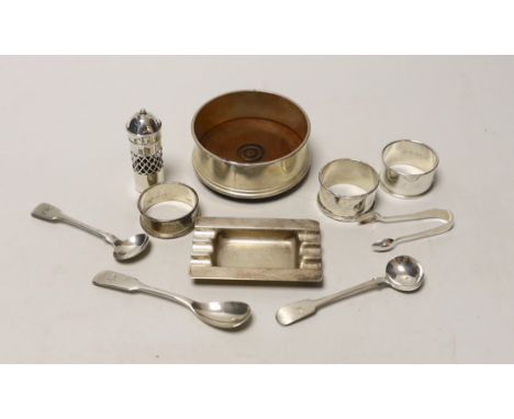 A silver coaster, ashtray, two napkin rings, cutlery etc.