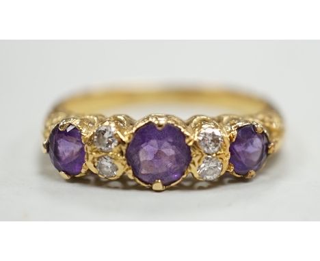 An 18ct, three stone amethyst and four stone diamond set half hoop ring, size Q/R, gross weight 4 grams.