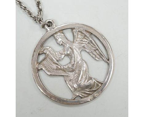 A late 1970's John Skelton silver pendant, depicting an angel with harp, diameter 63mm, on a sterling chain.