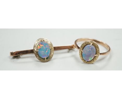 A 9ct and black opal doublet set bar brooch, 38mm and a matching ring, size R, gross weight 5.9 grams.