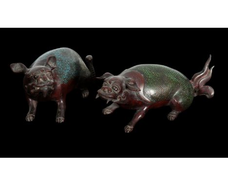A PAIR OF JAPANESE BRONZE DOGS Meiji period, both of the mystical dogs crouched, one decorated with blue enamel and tail form