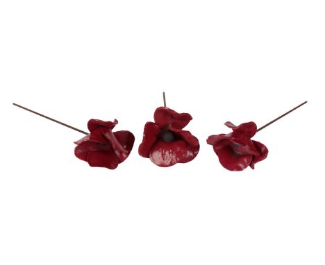 A COLLECTION OF CERAMIC POPPIES AFTER THOSE DESIGNED FOR THE TOWER OF LONDON BY PAUL CUMMINS the group of over twenty have la