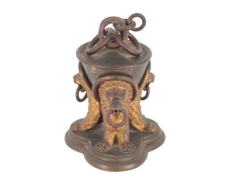 A 19TH CENTURY FRENCH BRONZE AND GILT BRONZE INKWELL modelled as a lidded urn supported by three lions, 19cm high x 12cm wide