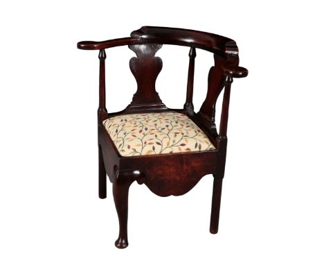 A GEORGE II PROVINCIAL WALNUT CORNER CHAIR mid 18th century, with twin vase shaped splats, over a square drop-in seat, with a