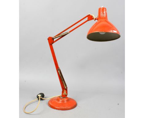 A Red Thousand and One Lamps Limited anglepoise lamp on circular base.