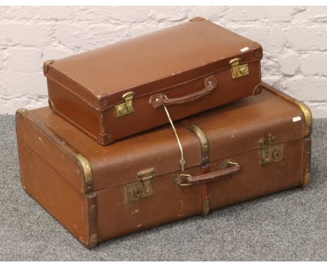 A wood bound travel trunk, along with a vintage suitcase with the original keys.