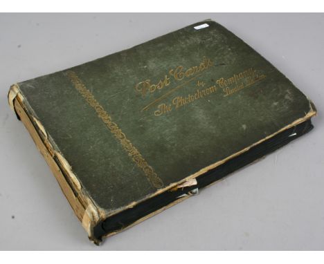 A vintage postcard album and contents of both colour and monochrome postcards.