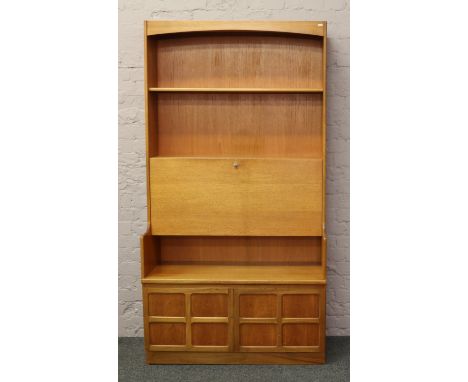 A retro teak open display wall unit incorporating drawer and panelled cupboard with central fitted bureau and concealed light