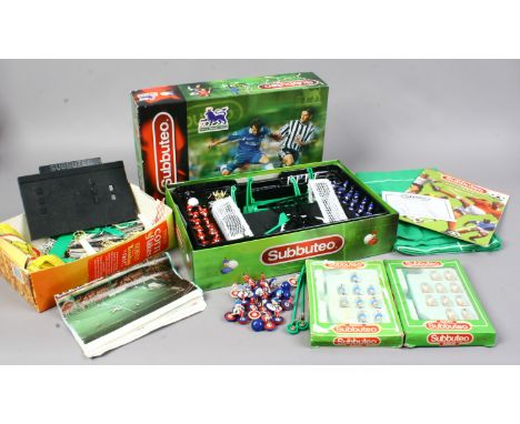 A boxed Subbuteo table top football game along with accessories.