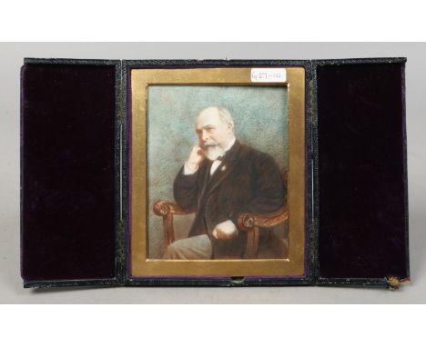 An Edwardian leather cased portrait miniatures of a bearded gentleman on strut stand, painted on opaque glass and with gilt m
