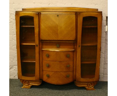 A carved light oak side by side bureau bookcase.