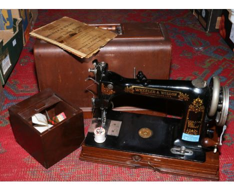 A cased Wheeler &amp; Wilson of Bridgeport, Connecticut, USA, D - 9 sewing machine, along with original instruction manual an