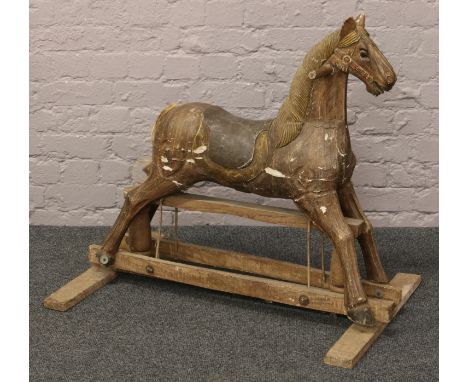 A vintage carved and painted child's rocking horse.Condition report intended as a guide only.Needs repair.