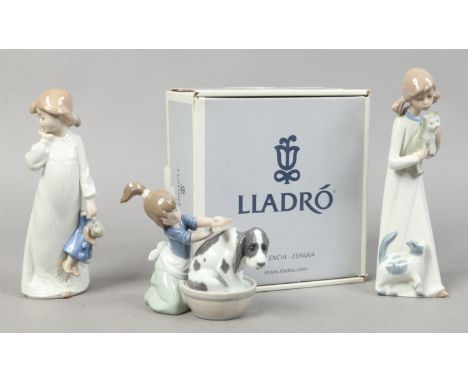 A boxed Lladro figure Bashful Bather along with two Nao figures of young girls.