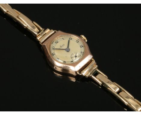 A ladies 9ct gold Avia manual watch head on gold plated bracelet strap with Arabic numeral markers and subsidiary seconds.