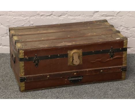 A wood and metal bound travel trunk.