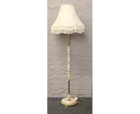 A brass and onyx standard lamp with cream shade.