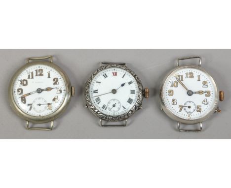 Three manual trench watch heads with wire lugs to include two silver examples.