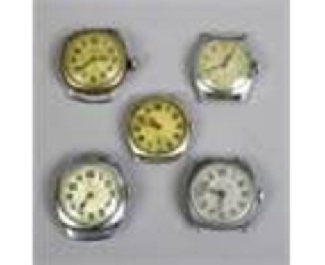 Five manual watch heads, some with wire lugs.
