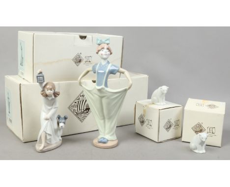 Four boxed Nao porcelain figures including a female clown, a young girl holding a lantern and two polar bear cubs.