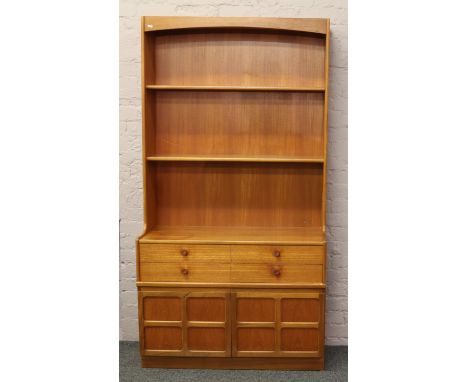 A retro 1970s teak open display wall unit incorporating drawer and panelled cupboard with concealed lighting.