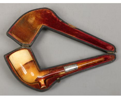 A cased meerschaum pipe with plain bowl and silver collar.