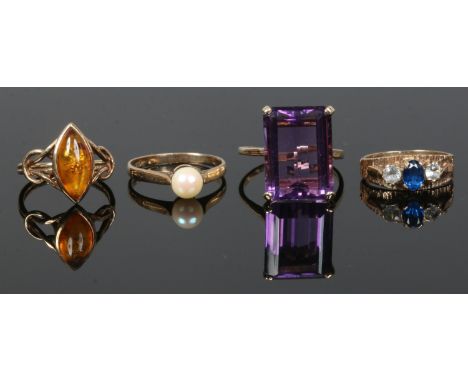 Four 9ct gold dress rings including amethyst set cocktail ring, amber,pearl and synthetic blue spinel etc.