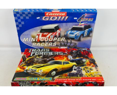 Scalextric - Carrera - A pair of boxed slot car racing sets. Include #G1031 1:64 Transformers and #60205 Mini Cooper Races. I
