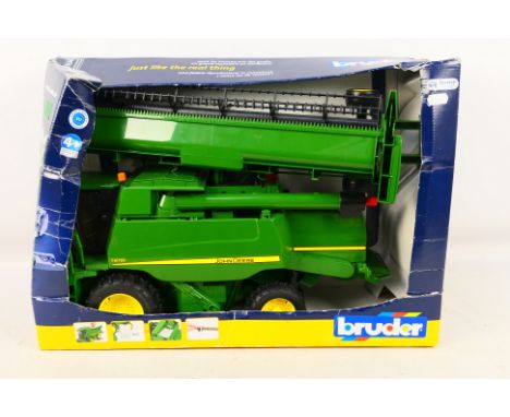 Bruder - A boxed plastic 1:16 scale John Deere Combine harvester T670i. The set shows some slightly dusty signs of display an