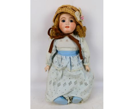 Handwerck - An 50cm tall porcine Max Handwerck bisque head doll numbered 120-13 in a blue dress and straw hat. Item has open 