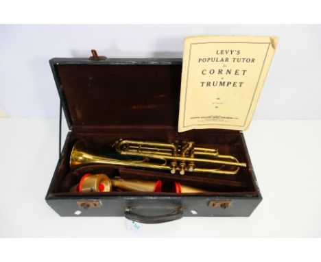 A brass trumpet marked Dixie, contained in fitted case with three Selmer mutes. [W]