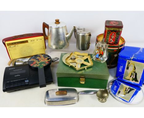 Lot comprising metalware including a brass bell, vintage radio, dressing table items and other. [W]
