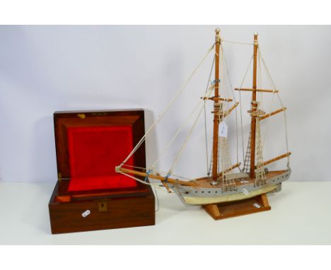 A vintage lap desk, approximately 14 cm x 30 cm x 22 cm and a scratch built two masted sailing ship model on stand, 57 cm (h)
