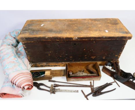 A vintage wooden tool chest with a small quantity of hand tools and a rug. [2]. [W]