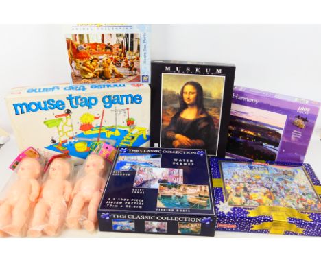Lot to include jigsaws, vintage Mouse Trap Game and three dolls sealed in original packaging. [W]