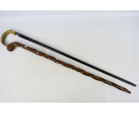 Two walking stick including one with silver mount, horn handle and ebonised shaft. [2]. [W]
