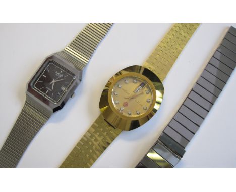 A Rado quartz Diastar Wristwatch the black square dial with cream hourly applied baton markers, sweep seconds hand and date a
