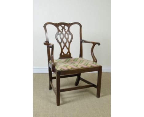 A Georgian Chippendale style Elbow Chair of generous proportions with shaped top rail, pierced splat, upholstered drop in sea