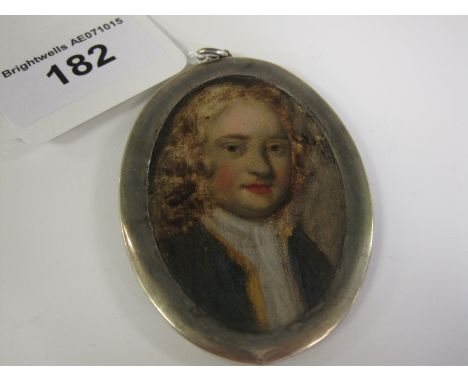 A painted Portrait Miniature of young man in green jacket in white metal frame